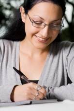 girl with glasses writing