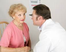 optometrist examining elder lady