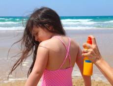 girl getting sunscreen